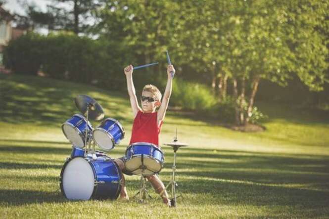 Boy playing drum set outdoors