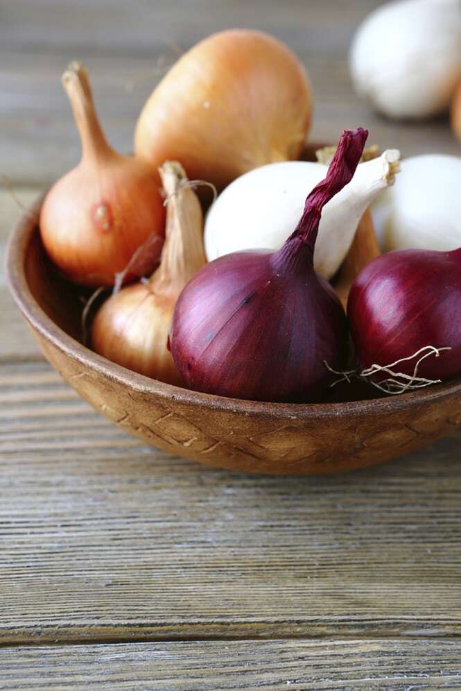 Onions in a wooden bowl